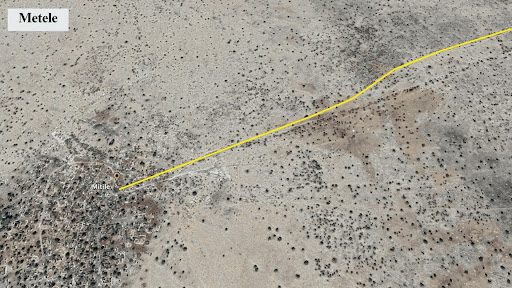 Aerial view of a desert region with a marked yellow path leading to a settlement labeled "Metele."